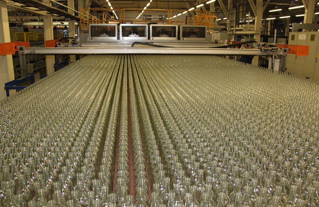 rows of bottles on a conveyor belt