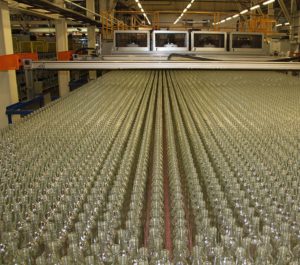 rows of glass bottles on conveyer belt